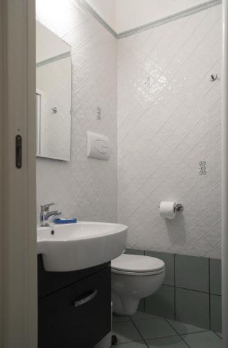 a white bathroom with a sink and a toilet at B&B Viacampo6 in Atrani