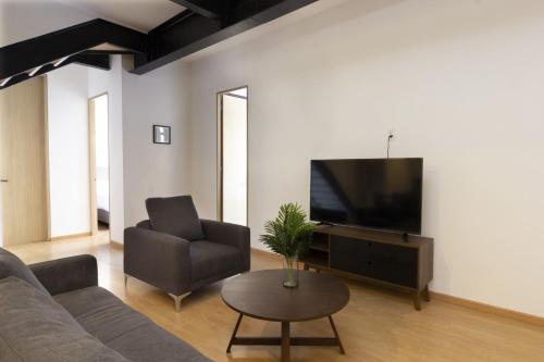 salon z kanapą i telewizorem w obiekcie El Doce by HomiRent w mieście Laborcillas
