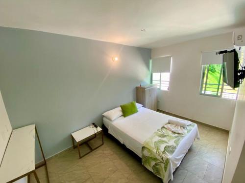 a bedroom with a bed and a television in it at Biohotel Rio Claro in Doradal