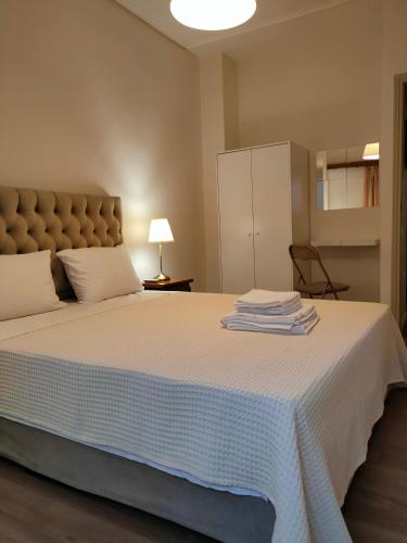 a bedroom with a large bed with a white blanket at CA Comfort Living in Kalamata
