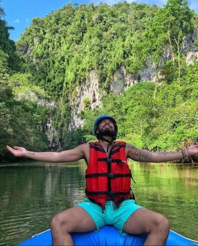 a man is sitting on a raft in the water at Biohotel Rio Claro in Doradal
