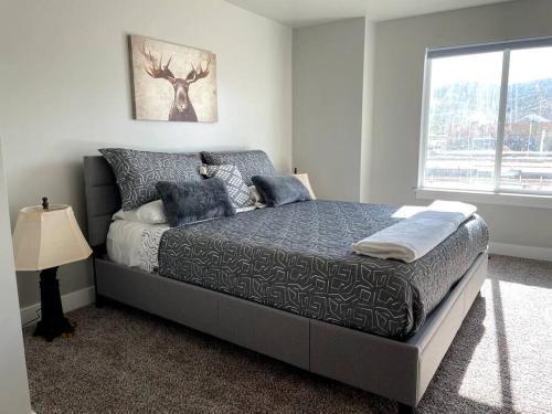 a bedroom with a bed with a deer picture on the wall at Lovely Condo! W/ free recreational vehicle parking in Garden City