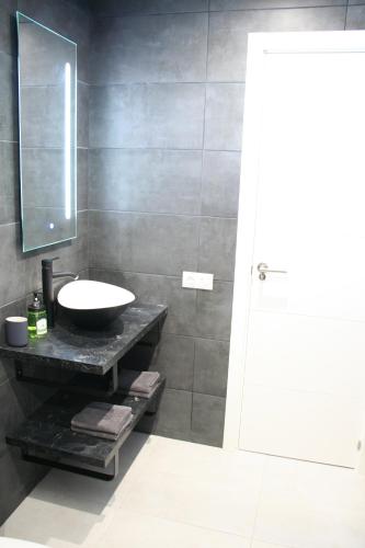 a bathroom with a sink and a mirror at Playa del Ingles D&M near Yumbo in San Bartolomé de Tirajana