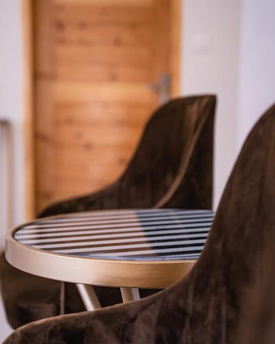 a wooden table with black and white chairs at ISLE OF HIGHLAND TOURS Guest House in Gilgit