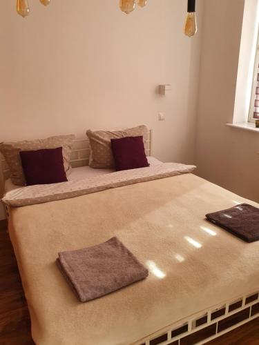 two beds in a room with two pillows on them at Apartament Lux in Koszalin