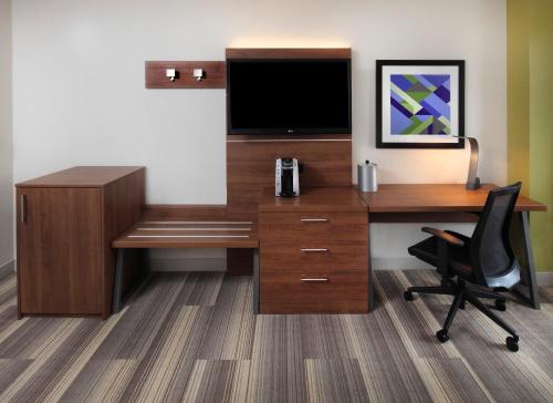 an office with a desk with a tv and a chair at Holiday Inn Express Hotel & Suites Fisherman's Wharf, an IHG Hotel in San Francisco