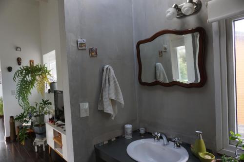 a bathroom with a sink and a mirror at Casa Towanda in San Carlos de Bariloche