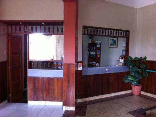 a restaurant lobby with a counter and a window at Hostal La Cascada in Lima