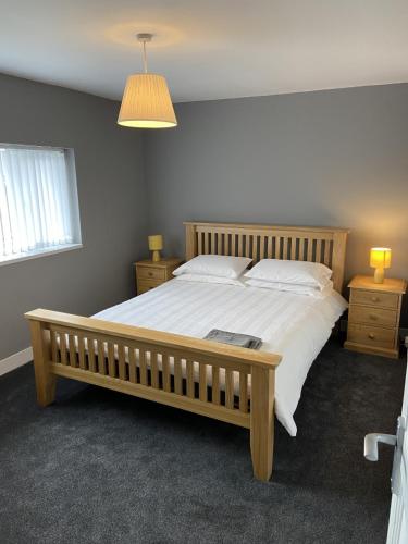 a bedroom with a large bed and two night stands at Sheffield spa view 2 bed house free parking in Sheffield