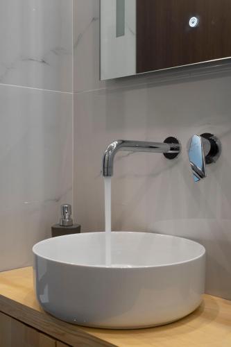 a sink in a bathroom with a faucet at 2 Bedroom condo with dream balcony in Athens