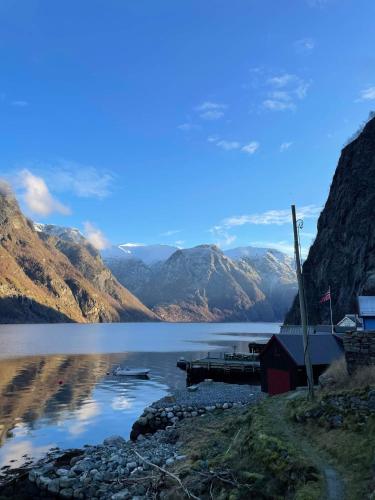 a view of a lake with a dock and mountains at Undredal Fjord Apartments in Undredal
