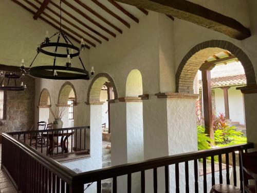 a porch with a table and a dining room at Hotel Boutique Posada Las Trampas in Honda