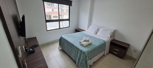 a bedroom with a bed with two stuffed animals on it at Luxor Paulo Miranda Home Service in João Pessoa