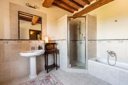 uma casa de banho com um lavatório, um chuveiro e um WC. em Villa Soiana em Soianella