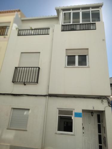 a white building with windows and a door at 'ESTRELA STAYS' in Lagos