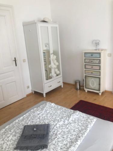 a bedroom with a dresser and a bed with a mirror at Villa Reder in Bad Sauerbrunn