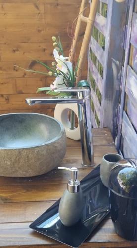 a sink and a faucet on a wooden table at Domaine Authentique de Rose in Porto-Vecchio