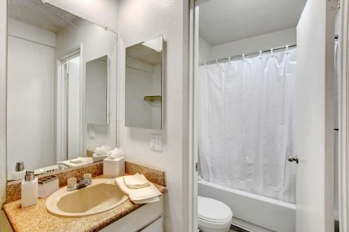a bathroom with a sink and a toilet and a shower at Siegel Slots and Suites (No Resort Fees) in Las Vegas