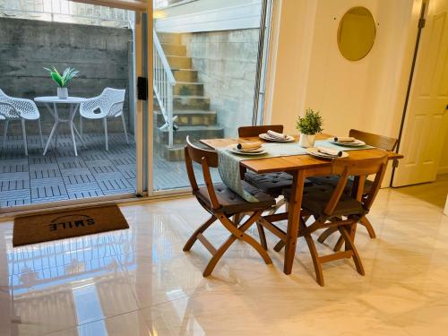 a wooden table and chairs in a room at Adorable 2-Bedroom Basement in Vancouver in Vancouver