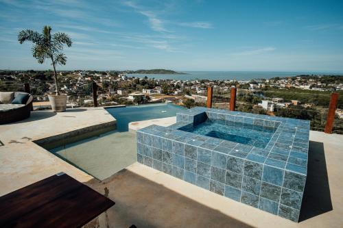 a swimming pool on the roof of a house at Terraço in Guarapari