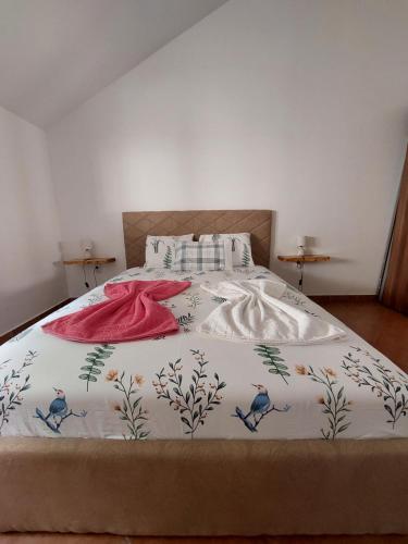 a bed with a bedspread with birds on it at Secret Mirage Apartment in Kotor