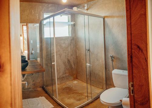 a shower stall in a bathroom with a toilet at Pousada Terraço Guarapari in Guarapari