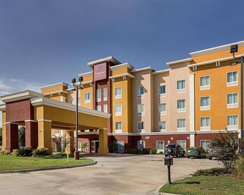 a hotel building with a parking meter in a parking lot at Comfort Suites near Tanger Outlet Mall in Gonzales