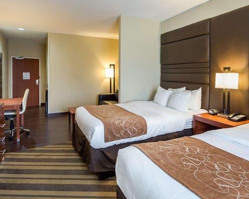 a hotel room with two beds and a desk at Comfort Suites near Tanger Outlet Mall in Gonzales