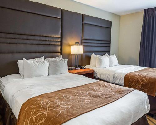 a hotel room with two beds and a lamp at Comfort Suites near Tanger Outlet Mall in Gonzales