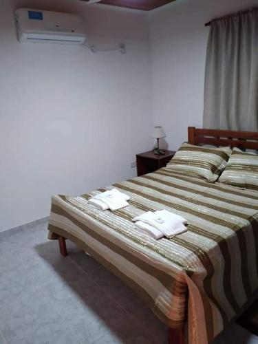 a bedroom with two beds with white towels on them at Departamento Odi in Federación