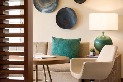 a living room with a couch and a table at Fairmont Scottsdale Princess in Scottsdale