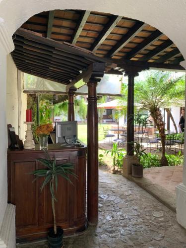 a wooden pergola with a computer on a patio at Villa de Antaño in Antigua Guatemala