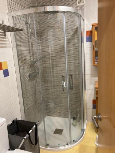 a shower with a glass door in a bathroom at Apartamento Bamuxela in Vigo