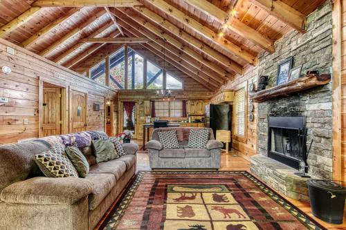 a living room with a couch and a fireplace at Always Kiss Me Goodnight-Hot Tub, Arcade, Near the Parkway! in Pigeon Forge