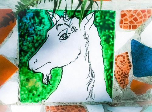 a drawing of a horse on a wall at Unicorn Reborn - Peaceful Rentals in San Marcos La Laguna