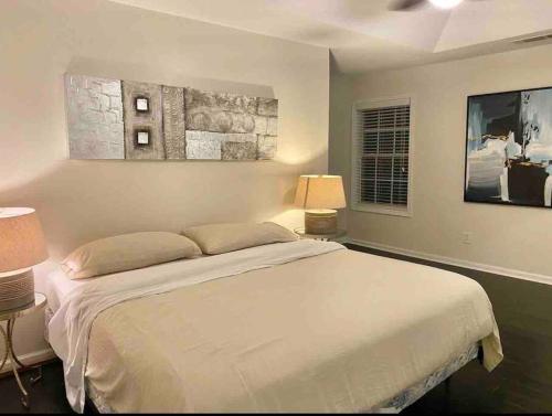 a bedroom with a large white bed and two lamps at New Modern house?A mins to Hwy i-85, 316 in Lawrenceville