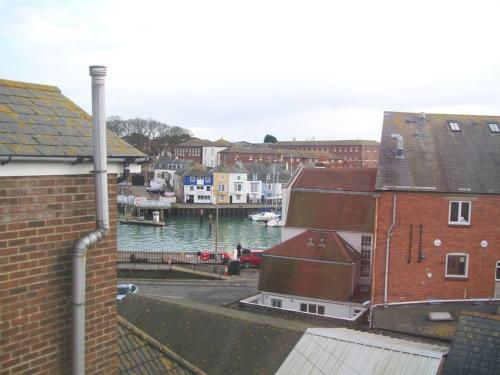 a view of a body of water with buildings at Boaters Guesthouse in Weymouth