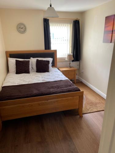 a bedroom with a large bed in a room at Fife Apartments in Dunfermline