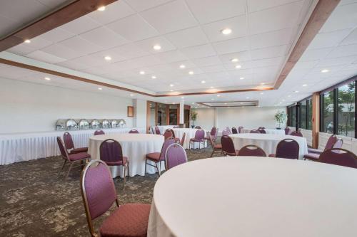 a banquet room with white tables and purple chairs at Best Western Hunt's Landing Hotel Matamoras Milford in Matamoras