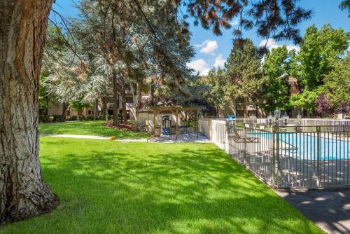 a yard with a fence and a pool at SureStay Plus Hotel by Best Western Reno Airport in Reno