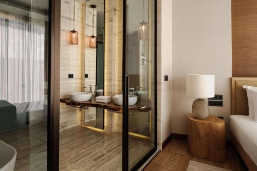 a bathroom with two sinks and a mirror at Radisson Blu Resort & Spa, Malta Golden Sands in Mellieħa