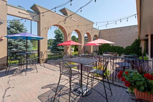 a patio with tables and chairs and umbrellas at Best Western Fairmont in Fairmont