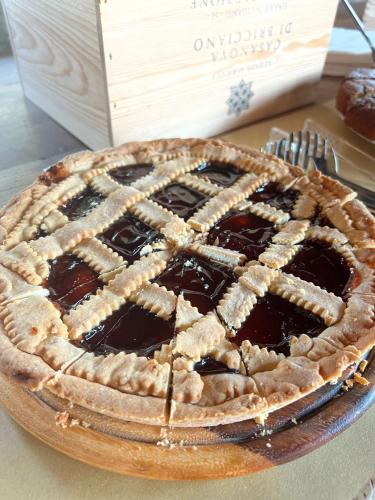 a chocolate pie sitting on a table next to a box at LOCANDA PODERE LE VIGNE in Radda in Chianti