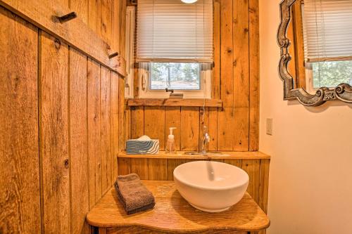 a bathroom with a bowl sink on a wooden wall at Cozy Suttons Bay Cottage with Shared Dock and Fire Pit in Suttons Bay