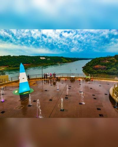 a group of people standing near a body of water at Hostel el Amanecer in Puerto Iguazú