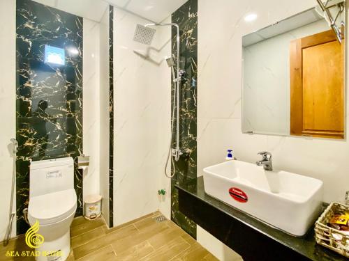 a bathroom with a sink and a toilet at Sea Star Hotel Quy Nhon in Quy Nhon