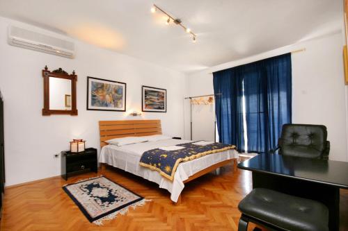 a bedroom with a bed and a desk and a chair at Apartments with a parking space Selce, Crikvenica - 5366 in Selce