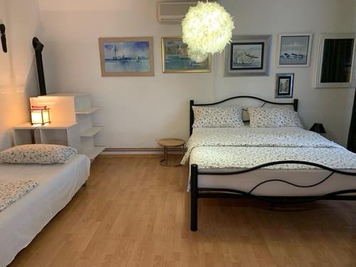 a bedroom with two beds and a chandelier at Apartment Selce 5366b in Selce