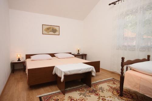 a bedroom with two beds and a rug at Apartments with a parking space Gradac, Makarska - 6757 in Gradac