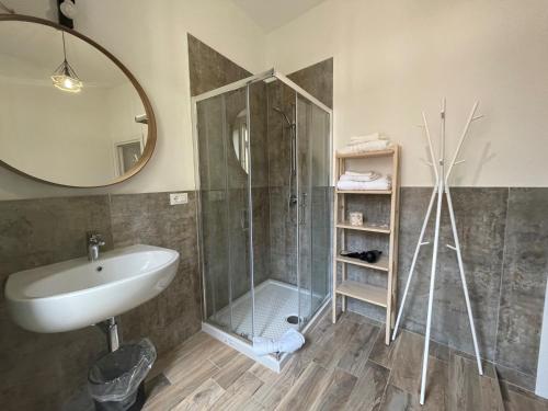 a bathroom with a shower and a sink and a mirror at La Rosa del Sulcis in Iglesias
